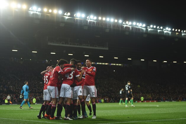 Manchester United players celebrate the opening goal scored by Manchester United's English midfielder Jesse Lingard during the English Premier League football match between Manchester United and Stoke City at Old Trafford in Manchester, north west England, on February 2, 2016. / AFP / PAUL ELLIS / RESTRICTED TO EDITORIAL USE. No use with unauthorized audio, video, data, fixture lists, club/league logos or 'live' services. Online in-match use limited to 75 images, no video emulation. No use in betting, games or single club/league/player publications.  /         (Photo credit should read PAUL ELLIS/AFP/Getty Images)