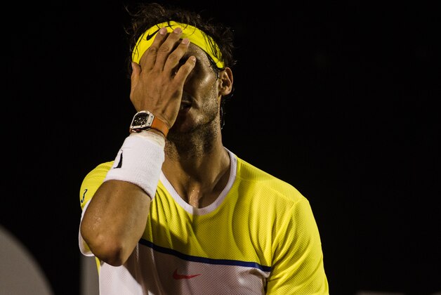 Rafael Nadal of Spain reacts during his match against Pablo Cuevas of Uruguay in the men's singles semi-final of the 2016 Rio Open tennis tournament in Rio de Janeiro, Brazil, on Februrary 21, 2016. / AFP / YASUYOSHI CHIBA (Photo credit should read YASUYOSHI CHIBA/AFP/Getty Images) Rafael Nadal of Spain reacts during his match against Pablo Cuevas of Uruguay in the men's singles semi-final of the 2016 Rio Open tennis tournament in Rio de Janeiro, Brazil, on Februrary 21, 2016. / AFP / YASUYOSHI CHIBA (Photo credit should read YASUYOSHI CHIBA/AFP/Getty Images)