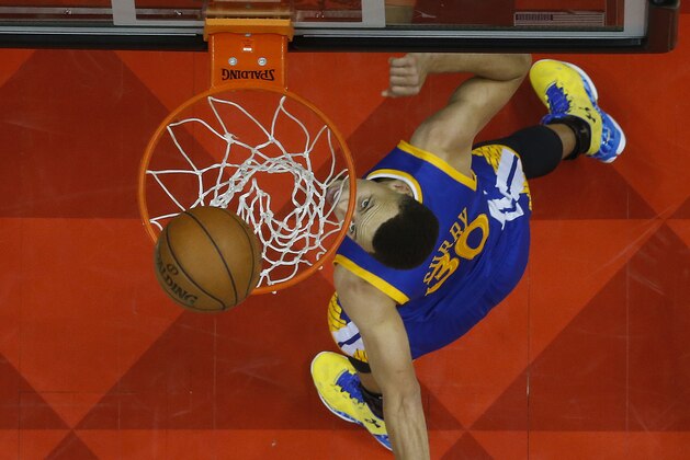Golden State Warriors guard Stephen Curry (30) scores against the Atlanta Hawks in the second half of an NBA basketball game Monday, Feb. 22, 2016, in Atlanta. Golden State won 102-92. (AP Photo/John Bazemore)