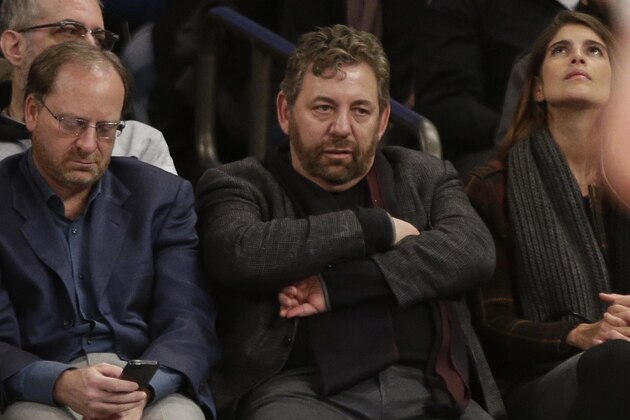 Madison Square Garden Chairman James Dolan, center, reacts during the first half of an NBA basketball game between the New York Knicks and the Charlotte Hornets, Saturday, Jan. 10, 2015, in New York. (AP Photo/Frank Franklin II)