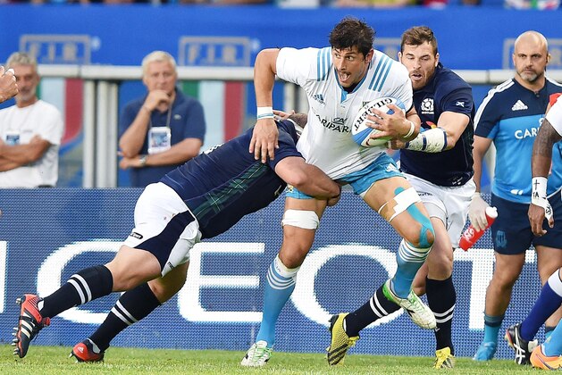 Italy's Tommaso Allan runs with the ball during a rugby test match between Italy and Scotland at the Olympic stadium, in Turin, Italy, Saturday, Aug. 22, 2015. (Alessandro Di Marco/ANSA via AP)