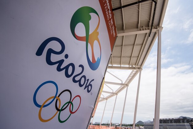 A banner with the Olympic logo for the Rio 2016 Olympic Games seen at the Olympic Tennis Centre of the Olympic Park in Rio de Janeiro, Brazil, on December 11, 2016.  AFP PHOTO / YASUYOSHI CHIBA / AFP / YASUYOSHI CHIBA        (Photo credit should read YASUYOSHI CHIBA/AFP/Getty Images)
