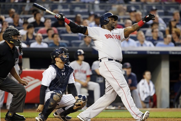 Boston Red Sox's David Ortiz hits a solo home run off New York Yankees starting pitcher Luis Severino as Yankees catcher John Ryan Murphy, middle, watches during the fourth inning of a baseball game at Yankee Stadium in New York, Wednesday, Aug. 5, 2015. (AP Photo/Kathy Willens)