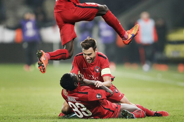 FC Midtjylland's Ebere Paul Onuachu, left, and Tim Sparvp, celebrate at the end of their Europa League round of 32 first leg soccer match against Manchester United at MCH Arena in Herning, Denmark, Thursday, Feb. 18, 2016. (Jens Dresling / Polfoto via AP) DENMARK OUT