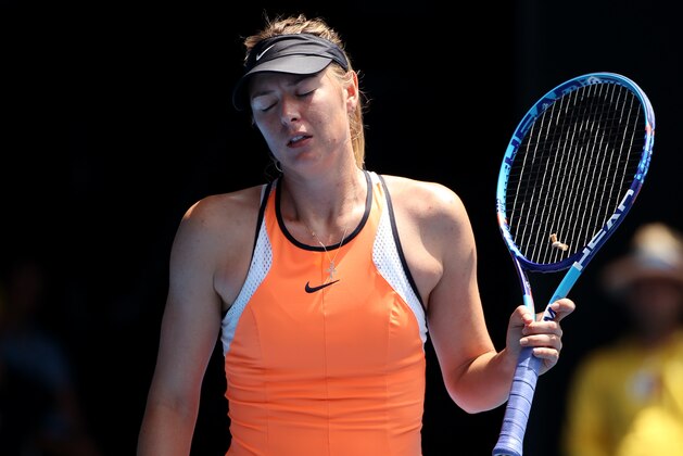 Maria Sharapova of Russia reacts after losing a point to Serena Williams of the United States during their quarterfinal match at the Australian Open tennis championships in Melbourne, Australia, Tuesday, Jan. 26, 2016.(AP Photo/Rick Rycroft)