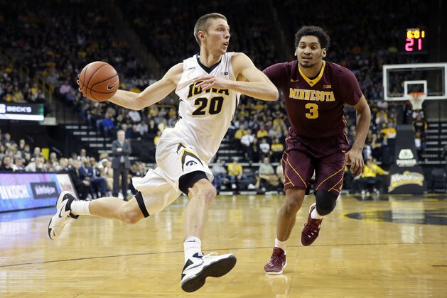 Iowa forward Jarrod Uthoff drives to the basket past Minnesota forward Jordan Murphy, right, during the first half of an NCAA college basketball game, Sunday, Feb. 14, 2016, in Iowa City, Iowa. (AP Photo/Charlie Neibergall)