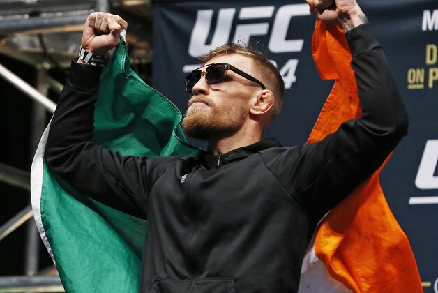Conor McGregor poses on stage during the weigh-in for UFC 194 Friday, Dec. 11, 2015, in Las Vegas. McGregor is scheduled to fight Jose Aldo in a featherweight championship bout Saturday in Las Vegas. (AP Photo/John Locher)
