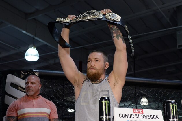 TORRANCE, CA - FEBRUARY 24:  UFC featherweight champion Conor McGregor holds up the championship belt during a news conference with lightweight contender Nate Diaz at UFC Gym February 24, 2016, in Torrance, California. (Photo by Kevork Djansezian/Getty Images)