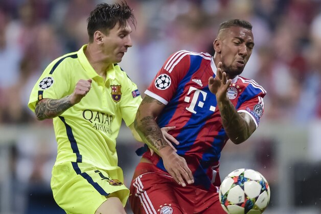 Bayern Munich's defender Jerome Boateng (R) and Barcelona's Argentinian forward Lionel Messi vie for the ball during UEFA Champions League semi-final second leg football match FC Bayern Munich vs FC Barcelona in Munich, southern Germany, on May 12, 2015.     AFP PHOTO / STR        (Photo credit should read -/AFP/Getty Images)