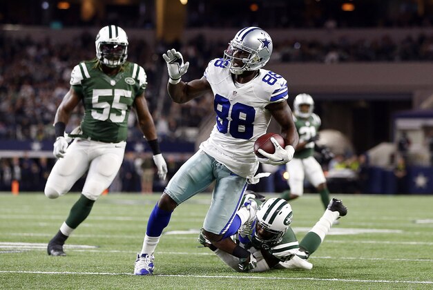 Dec 19, 2015; Arlington, TX, USA; Dallas Cowboys wide receiver Dez Bryant (88) breaks the tackle of New York Jets cornerback Darrelle Revis (24) to score a touchdown in the second quarter at AT&T Stadium. Mandatory Credit: Tim Heitman-USA TODAY Sports