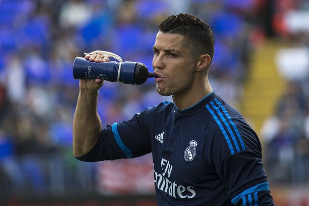 MALAGA, SPAIN - FEBRUARY 21: Cristiano Ronaldo of Real Madrid CF drinks from a bottle prior to start the La Liga match between Malaga CF and Real Madrid CF at La Rosaleda Stadium on February 21, 2016 in Malaga, Spain.  (Photo by Gonzalo Arroyo Moreno/Getty Images)