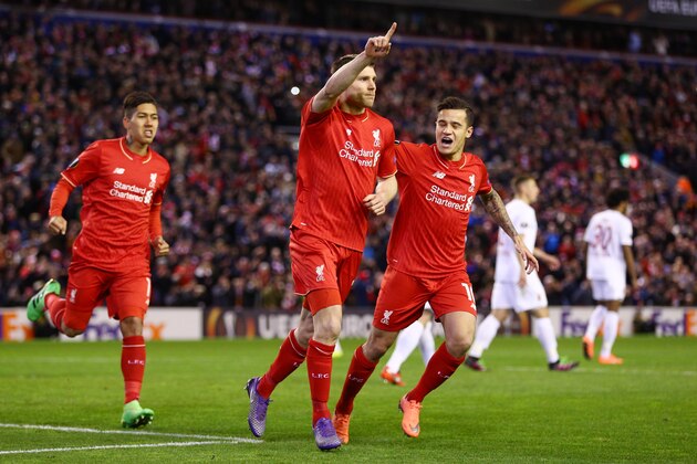 LIVERPOOL, ENGLAND - FEBRUARY 25:  James Milner (C) of Liverpool celebrates scoring his team's first goal with his team mates Roberto Firmino (L) and Philippe Coutinho (R) during the UEFA Europa League Round of 32 second leg match between Liverpool and FC Augsburg at Anfield on February 25, 2016 in Liverpool, United Kingdom.  (Photo by Clive Brunskill/Getty Images)