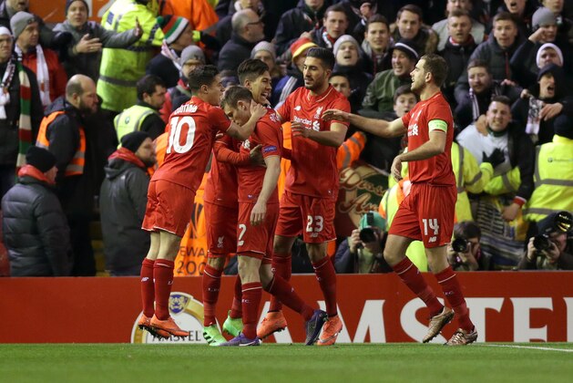 Liverpool's James Milner, center left, celebrates with teammates scoring his side's first goal from the penalty spot, during the Europa League round of 32 second leg soccer match between Liverpool and FC Augsburg in Liverpool, England, Thursday Feb. 25, 2016. (AP Photo/Clint Hughes)