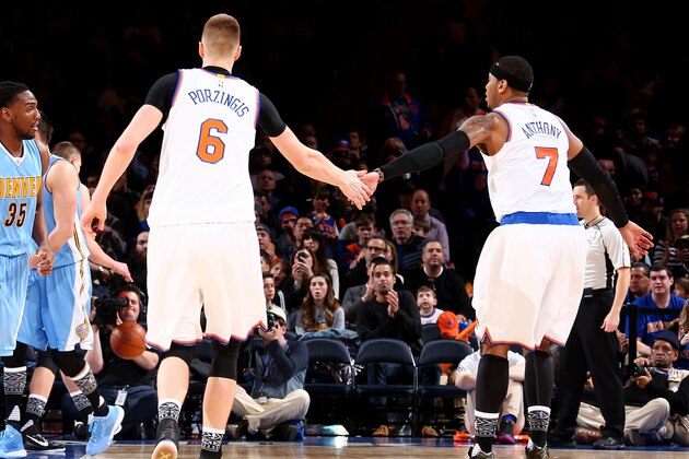 NEW YORK, NY - FEBRUARY 7: Kristaps Porzingis #6 and Carmelo Anthony #7 of the New York Knicks high five each other during the game against the Denver Nuggets on February 7, 2016 at Madison Square Garden in New York City, New York.  NOTE TO USER: User expressly acknowledges and agrees that, by downloading and or using this photograph, User is consenting to the terms and conditions of the Getty Images License Agreement. Mandatory Copyright Notice: Copyright 2016 NBAE  (Photo by Nathaniel S. Butler/NBAE via Getty Images)