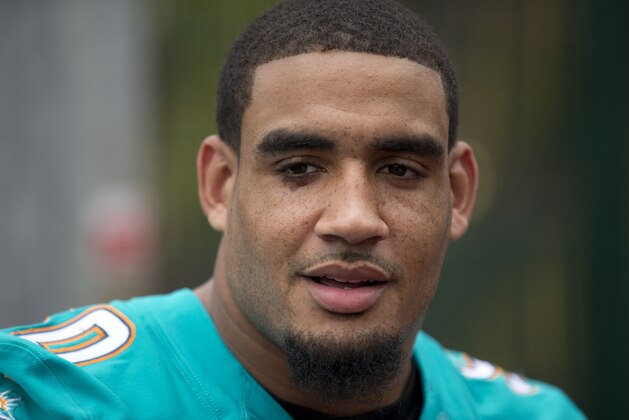 NFL team Miami Dolphins' defensive end Olivier Vernon speaks during a media interview during an NFL Summer Bowl tournament for kids from six London schools that have taken part in a football and education programme, at the Black Prince Community Hub in south London, Wednesday, July 15, 2015. The NFL will stage three international series regular-season games in autumn 2015 at Wembley Stadium in London.  (AP Photo/Matt Dunham)