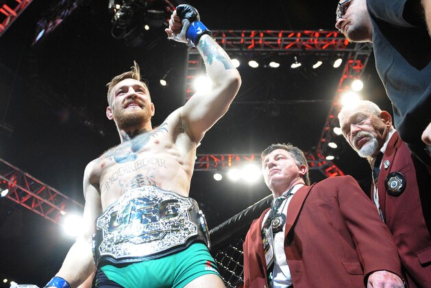 December 12, 2015; Las Vegas, NV, USA; Conor McGregor exits the octagon following his championship victory against Jose Aldo during UFC 194 at MGM Grand Garden Arena. Mandatory Credit: Gary A. Vasquez-USA TODAY Sports