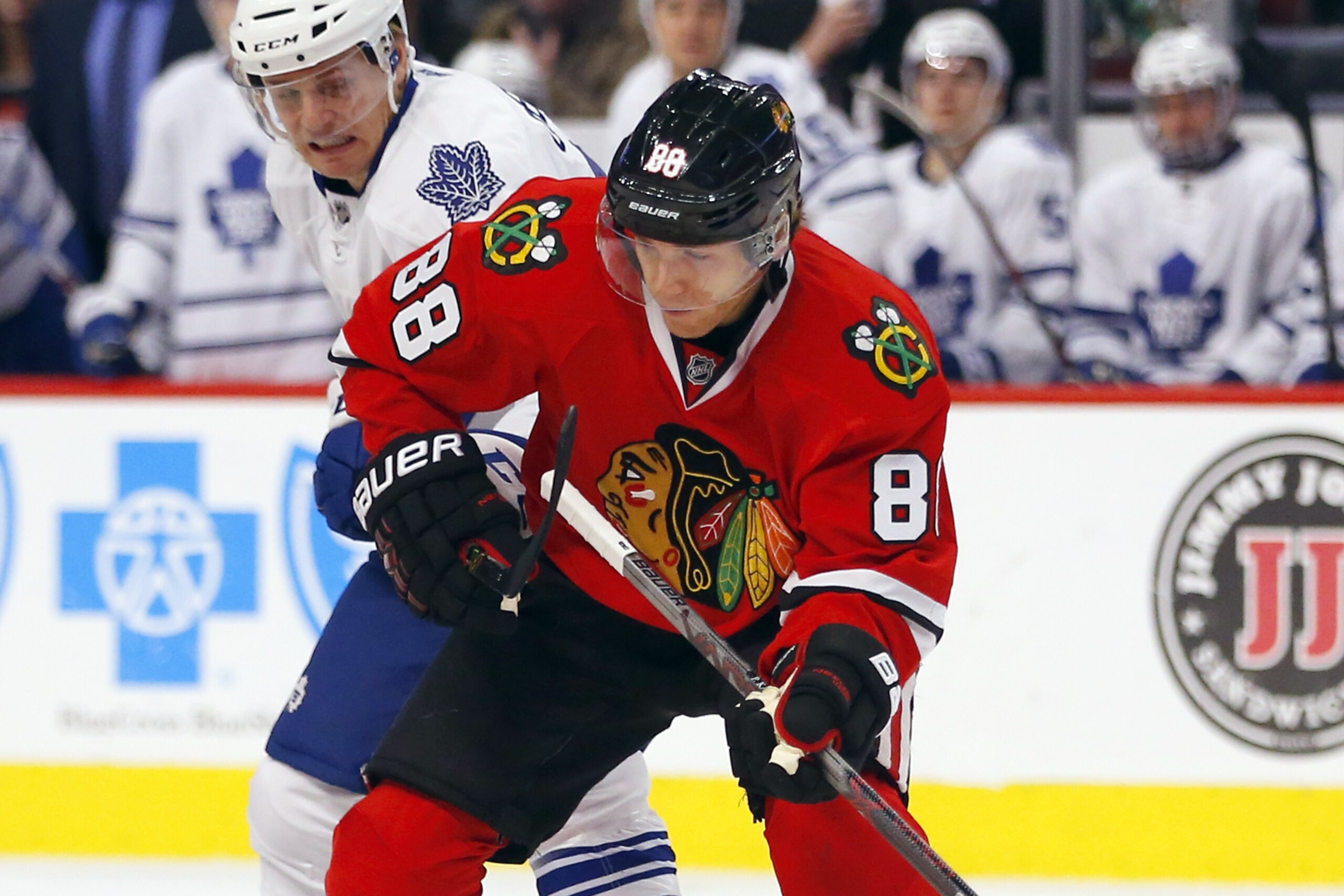 Chicago Blackhawks right wing Patrick Kane (88) battles Toronto Maple Leafs left wing Colin Greening (38) during the first period of an NHL hockey game on Monday, Feb. 15, 2016, in Chicago. (AP Photo/Jeff Haynes)