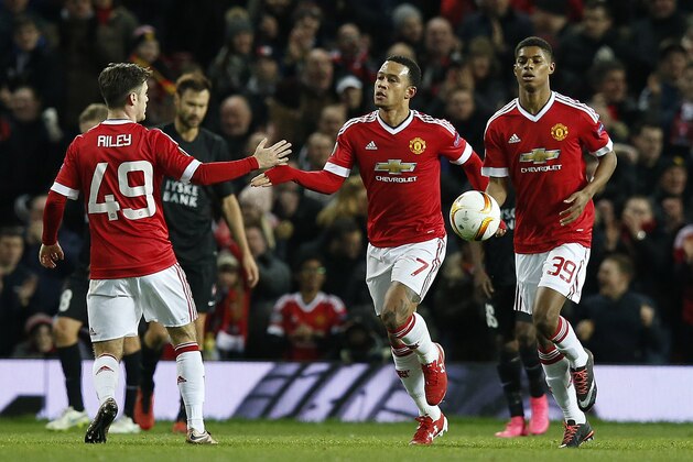 United’s Memphis Depay, center, celebrates after scoring during the Europa League round of 32 second leg soccer match between Manchester United and FC Midtjylland in Manchester, England, Thursday, Feb. 25, 2016 . (AP Photo/Jon Super)