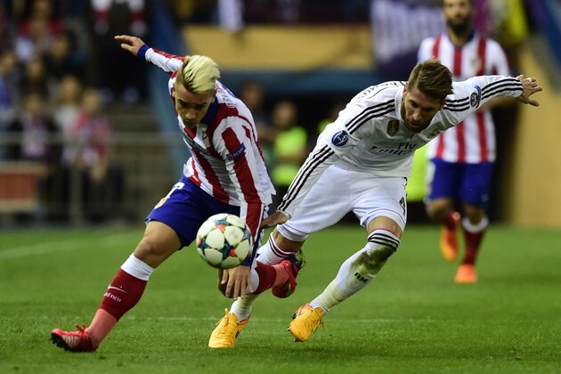 Atletico Madrid's French forward Antoine Griezmann (L) vies with Real Madrid's defender Sergio Ramos during the UEFA Champions League quarter final first leg football match Atletico de Madrid vs Real Madrid CF at the Vicente Calderon stadium in Madrid on April 14, 2015.    AFP PHOTO / JAVIER SORIANO        (Photo credit should read JAVIER SORIANO/AFP/Getty Images)