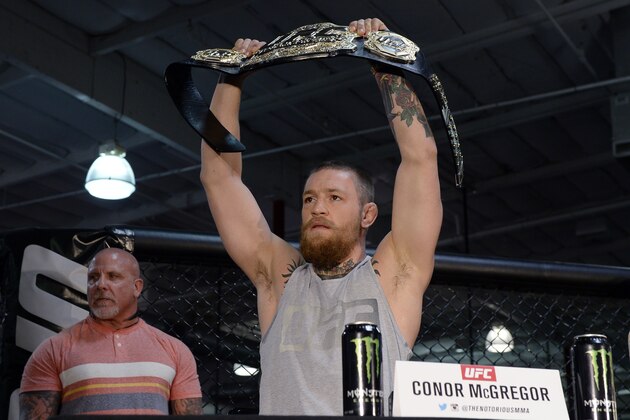 TORRANCE, CA - FEBRUARY 24:  UFC featherweight champion Conor McGregor holds up the championship belt during a news conference with lightweight contender Nate Diaz at UFC Gym February 24, 2016, in Torrance, California. (Photo by Kevork Djansezian/Getty Images)