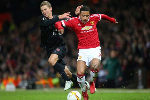 MANCHESTER, ENGLAND - FEBRUARY 25:  Memphis Depay of Manchester United and Andre Romer of FC Midtjylland compete for the ball during the UEFA Europa League Round of 32 second leg match between Manchester United and FC Midtjylland at Old Trafford on February 25, 2016 in Manchester, United Kingdom.  (Photo by Alex Livesey/Getty Images)