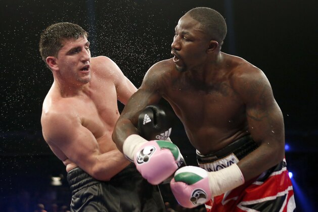 Britain's Ola Afolabi, right, lands a punch to Germany's Marco Huck during their WBO cruiserweight championship title bout in Berlin, Germany, Saturday, June 8, 2013. Huck retained his WBO belt by defeating Afolabi by majority decision on Saturday.  (AP Photo/Michael Sohn)