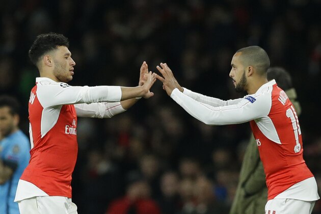 Arsenal's Alex Oxlade-Chamberlain, left is substituted and replaced by Arsenal's Theo Walcott during the Champions League round of 16 first leg soccer match between Arsenal and Barcelona at the Emirates stadium London, Tuesday, Feb. 23, 2016. (AP Photo/Matt Dunham)