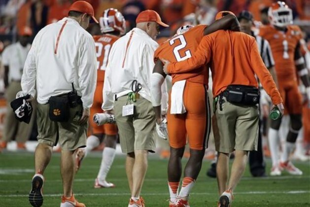 Clemson's Mackensie Alexander (2) is helped off the field during the first half of the NCAA college football playoff championship game Monday, Jan. 11, 2016, in Glendale, Ariz. (AP Photo/Chris Carlson)