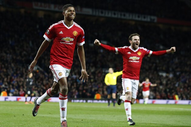 United’s Marcus Rashford, left, celebrates after scoring  during the Europa League round of 32 second leg soccer match between Manchester United and FC Midtjylland in Manchester, England, Thursday, Feb. 25, 2016 . (AP Photo/Jon Super)