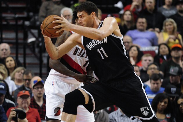 Brooklyn Nets center Brook Lopez (11) drives to the basket on Portland Trail Blazers center Ed Davis during the fourth quarter of an NBA basketball game in Portland, Ore., Tuesday, Feb. 23, 2016. The Blazers won 112-104. (AP Photo/Steve Dykes)