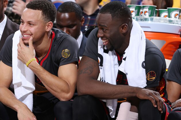 PORTLAND, OR - FEBRUARY 19:  Stephen Curry #30 of the Golden State Warriors and Draymond Green #23 of the Golden State Warriors laugh on the bench during the game against the Portland Trail Blazers on February 19, 2016 at the Moda Center Arena in Portland, Oregon. NOTE TO USER: User expressly acknowledges and agrees that, by downloading and or using this photograph, user is consenting to the terms and conditions of the Getty Images License Agreement. Mandatory Copyright Notice: Copyright 2016 NBAE (Photo by Sam Forencich/NBAE via Getty Images)