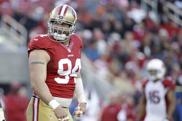San Francisco 49ers defensive tackle Justin Smith (94) smiles during the second half of an NFL football game against the Arizona Cardinals in Santa Clara, Calif., Sunday, Dec. 28, 2014. (AP Photo/Marcio Jose Sanchez)