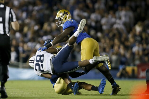 UCLA linebacker Myles Jack stops BYU running back Adam Hine during an NCAA college football game, Saturday, Sept. 19, 2015, in Pasadena, Calif. UCLA won 24-23. (AP Photo/Danny Moloshok)