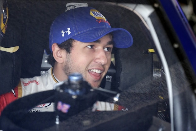 Chase Elliott talks to a crew member before practice for Sunday's Daytona 500 NASCAR Sprint Cup Series auto race at Daytona International Speedway in Daytona Beach, Fla., Saturday, Feb. 20, 2016. (AP Photo/Terry Renna)