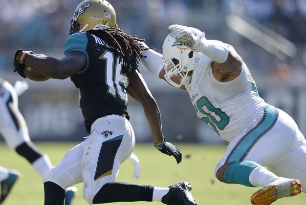 Oct 26, 2014; Jacksonville, FL, USA; Miami Dolphins defensive end Olivier Vernon (50) tackles Jacksonville Jaguars running back Denard Robinson (16) at EverBank Field. Mandatory Credit: Richard Dole-USA TODAY Sports