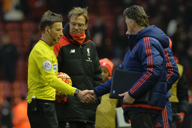 Manchester United's Welsh assistant manager Ryan Giggs (R obscured) shakes hands with referee Mark Clattenburg (L) as Manchester United's Dutch manager Louis van Gaal (R) and Liverpool's German manager Jurgen Klopp (2L) look on after the English Premier League football match between Liverpool and Manchester United at Anfield in Liverpool, northwest England, on January 17, 2016. Wayne Rooney scored the winning goal in Manchester United's 1-0 victory over Liverpool. AFP PHOTO / PAUL ELLIS

RESTRICTED TO EDITORIAL USE. No use with unauthorized audio, video, data, fixture lists, club/league logos or 'live' services. Online in-match use limited to 75 images, no video emulation. No use in betting, games or single club/league/player publications. / AFP / PAUL ELLIS        (Photo credit should read PAUL ELLIS/AFP/Getty Images)