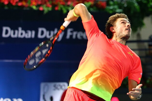 Stanislas Wawrinka of Switzerland serves to Marcos Baghdatis of Cyprus during their ATP final tennis match of the Dubai Duty Free Tennis Championships on February 27, 2016.      / AFP / MARWAN NAAMANI        (Photo credit should read MARWAN NAAMANI/AFP/Getty Images)