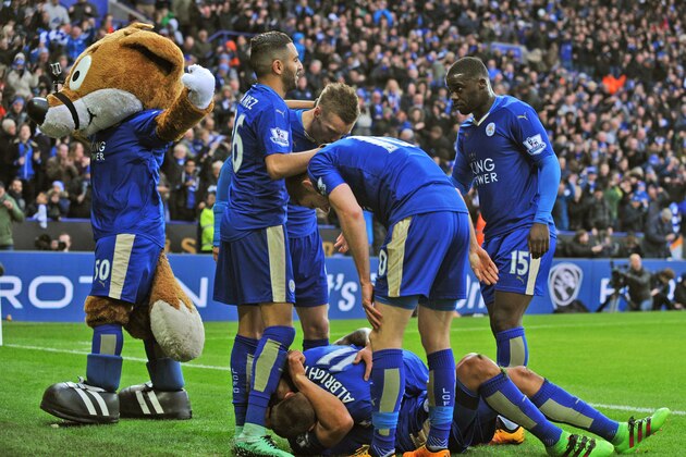 Leicester players celebrate after Leonardo Ulloa, hidden, scored against Norwich during the English Premier League soccer match between Leicester City and Norwich City at the King Power Stadium in Leicester, England, Saturday, Feb. 27, 2016. (AP Photo/Rui Vieira)