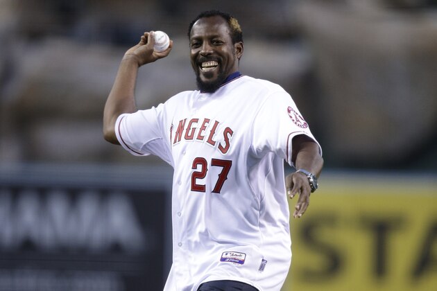 Vladimir Guerrero throws the ceremonial first pitch before an opening day baseball game between the Los Angeles Angels and the Seattle Mariners on Monday, March 31, 2014, in Anaheim, Calif. Guerrero signed a one-day contract to retire with the Los Angeles Angels on Monday. (AP Photo/Jae C. Hong) Vladimir Guerrero throws the ceremonial first pitch before an opening day baseball game between the Los Angeles Angels and the Seattle Mariners on Monday, March 31, 2014, in Anaheim, Calif. Guerrero signed a one-day contract to retire with the Los Angeles Angels on Monday. (AP Photo/Jae C. Hong)