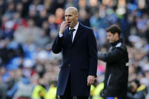 Real Madrid's headcoach Zinedine Zidane reacts as he watches the Spanish La Liga soccer match between Real Madrid and Atletico Madrid at the Santiago Bernabeu stadium in Madrid, Spain, Saturday Feb. 27, 2016. Atletico won the match 1-0.  (AP Photo/Paul White)