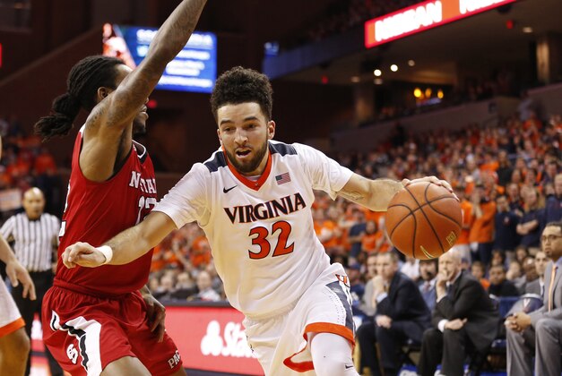 Feb 15, 2016; Charlottesville, VA, USA; Virginia Cavaliers guard London Perrantes (32) dribbles the ball as North Carolina State Wolfpack guard Anthony Barber (12) defends in the second half at John Paul Jones Arena. The Cavaliers won 73-53. Mandatory Credit: Geoff Burke-USA TODAY Sports