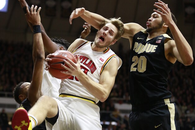 Maryland guard Jake Layman, front left, rebounds the basketball while defended by Purdue center A.J. Hammons (20) in the first half of an NCAA college basketball game, Saturday, Feb. 27, 2016, in West Lafayette, Ind. (AP Photo/R Brent Smith)