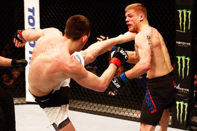 LONDON, ENGLAND - FEBRUARY 27:  Scott Askham of England (L) KO's Chris Dempsey of the USA with a high kick in their Middleweight bout during the UFC Fight Night held at at Indigo at The O2 Arena on February 27, 2016 in London, England.  (Photo by Dean Mouhtaropoulos/Zuffa LLC/Zuffa LLC via Getty Images)