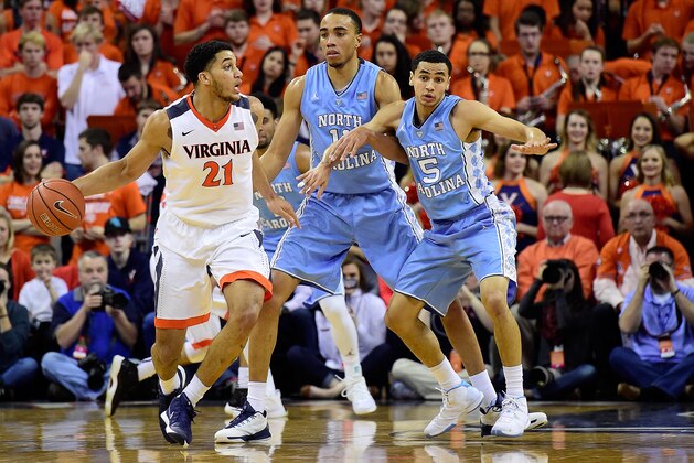 CHARLOTTESVILLE, VA - FEBRUARY 27:  Isaiah Wilkins #21 of the Virginia Cavaliers dribbles the ball against Marcus Paige #5 of the North Carolina Tar Heels in the first half during their game at John Paul Jones Arena on February 27, 2016 in Charlottesville, Virginia.  (Photo by Patrick McDermott/Getty Images)