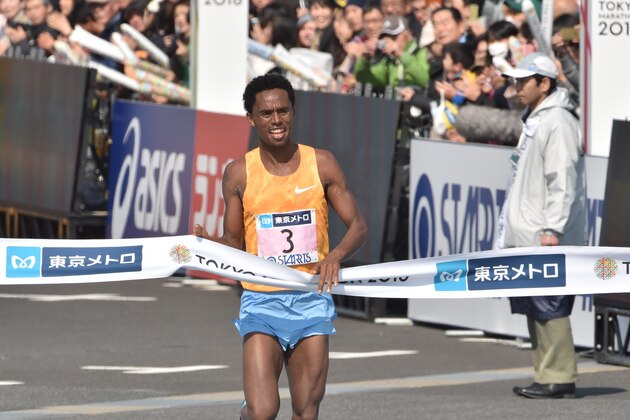 Ethiopia's Feyisa Lilesa celebrates as he crosses the finish line to win the men's category of the Tokyo Marathon in Tokyo on February 28, 2016. AFP PHOTO / KAZUHIRO NOGI / AFP / KAZUHIRO NOGI        (Photo credit should read KAZUHIRO NOGI/AFP/Getty Images)