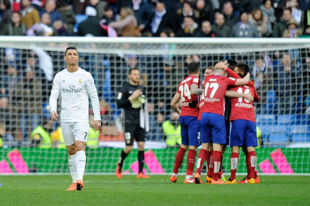 MADRID, SPAIN - FEBRUARY 27:  Cristiano Ronaldo of Real Madrid walks away from celebrating Atletico Madrid players after Atletico beat Real 1-0 in the La Liga match between Real Madrid CF and Club Atletico de Madrid at Estadio Santiago Bernabeu on February 27, 2016 in Madrid, Spain.  (Photo by Denis Doyle/Getty Images)