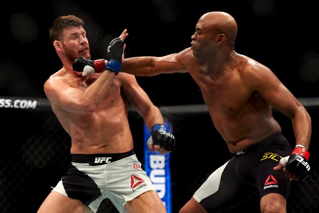 British fighter Michael Bisping (L) competes with Anderson Silva of Brazil (R) during their middleweight bout at the Ultimate Fighting Championship (UFC) Fight Night event in London on February 27, 2016.
Bisping beat Silva on a judge's decision over five rounds. / AFP / NIKLAS HALLE'N        (Photo credit should read NIKLAS HALLE'N/AFP/Getty Images)