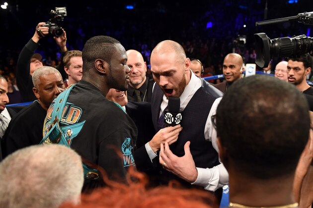 Tyson Fury of Britain (R) challeges Deontay Wilder of the US (L) after Wilder defeated Artur Szpilka of Poland in their WBC Heavyweight Championship bout at Barclay's Center in Brooklyn, New York, on January 16, 2016. 
Wilder knocked out Szpilka in the ninth round.  / AFP / AFP PHOTO / DON EMMERT        (Photo credit should read DON EMMERT/AFP/Getty Images)