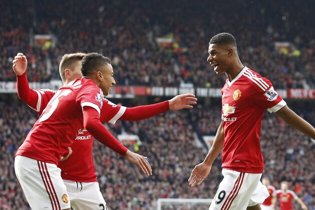 Manchester United's Marcus Rashford, runs to his teammates after scoring his sides second goal of the game during the English Premier League soccer match between Manchester United and Arsenal at Old Trafford Stadium, Manchester, England, Sunday, Feb. 28, 2016. (AP Photo/Jon Super)