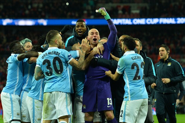 Manchester CIty's Argentinian goalkeeper Willy Caballero (C) celebrates with his team-mates after he saved three penalties in the penalty shoot-out to help Manchester City win the English League Cup final football match between Liverpool and Manchester City at Wembley Stadium in London on February 28, 2016. / AFP / GLYN KIRK / RESTRICTED TO EDITORIAL USE. No use with unauthorized audio, video, data, fixture lists, club/league logos or 'live' services. Online in-match use limited to 75 images, no video emulation. No use in betting, games or single club/league/player publications.  /         (Photo credit should read GLYN KIRK/AFP/Getty Images)